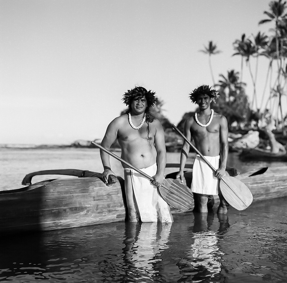 a man carrying a surfboard out of the water